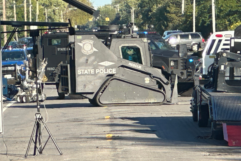 A police battering ram vehicle is positioned outside the home of the suspected church shooter in Grand Blanc, Mich., Sunday, Sept. 28, 2025. (AP Photo/Corey Williams)
