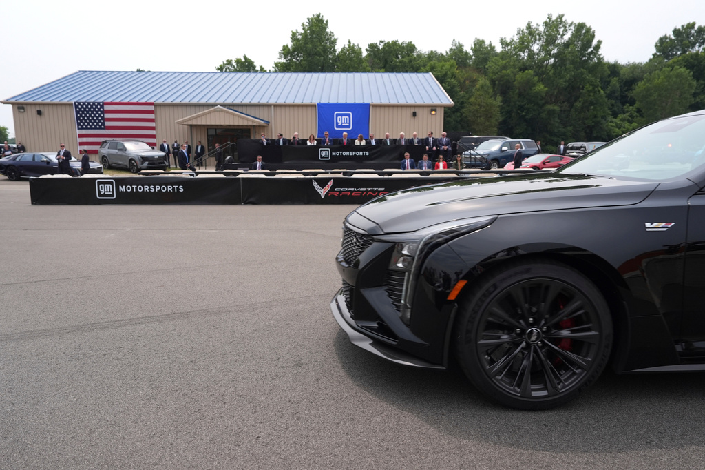 President Donald Trump, seated in background sixth from left, watches a driving demonstration at General Motors proving ground, Monday, July 27, 2026, in Milford, Mich. (AP Photo/Alex Brandon)