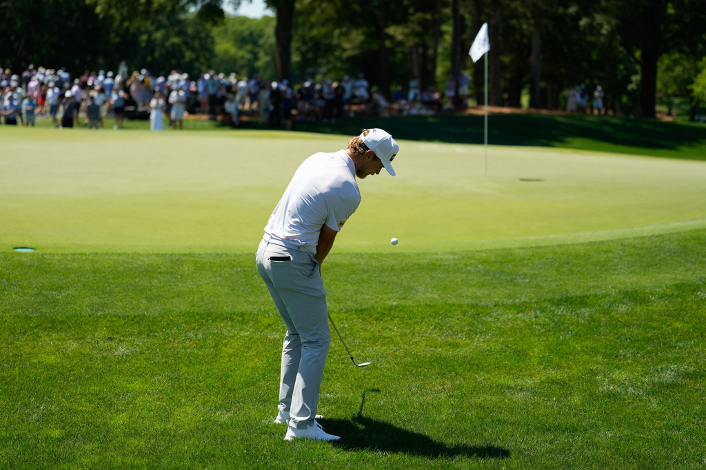 Kristoffer Reitan, of Norway, chips on to the green on the fifth hole during the final round of the Truist Championship golf tournament at the Quail Hollow Club, Sunday, May 10, 2026, in Charlotte, N.C. (AP Photo/Chris Carlson)
