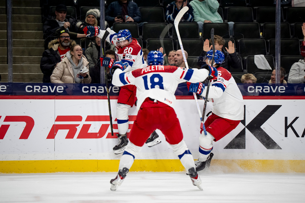 Czechia's Adam Benak celebrates his goal with teammates Tomas Poletin (18) and Radim Mrtka during the second period of an IIHF World Junior Hockey Championship semifinals game, Sunday, Jan. 4, 2026, in St. Paul, Minn. (Christopher Katsarov/The Canadian Press via AP)