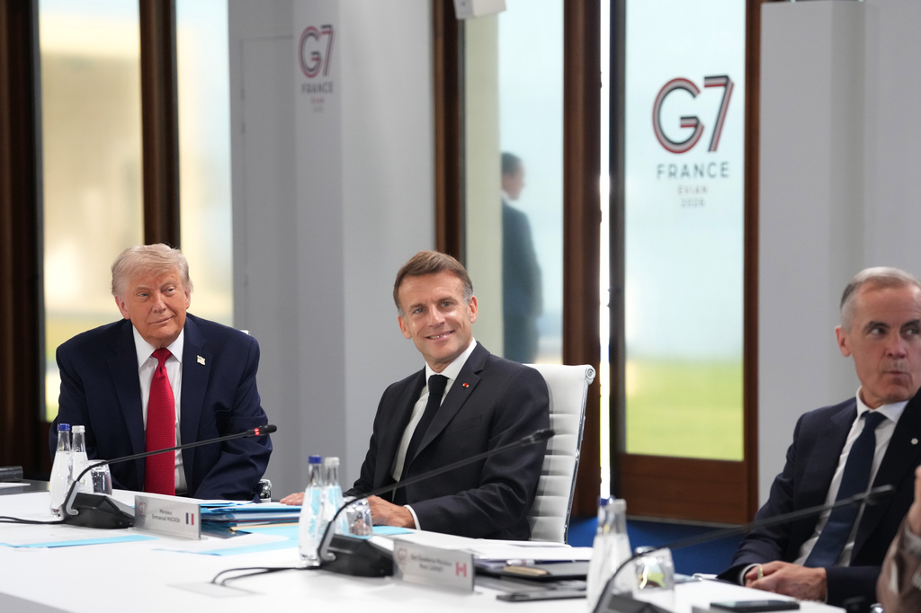 From left, U.S. President Donald Trump, French President Emmanuel Macron and Canadian Prime Minister Mark Carney during a working session at the G7 summit in Evian-les-Bains, France, Wednesday, June 17, 2026. (AP Photo/Thibault Camus)