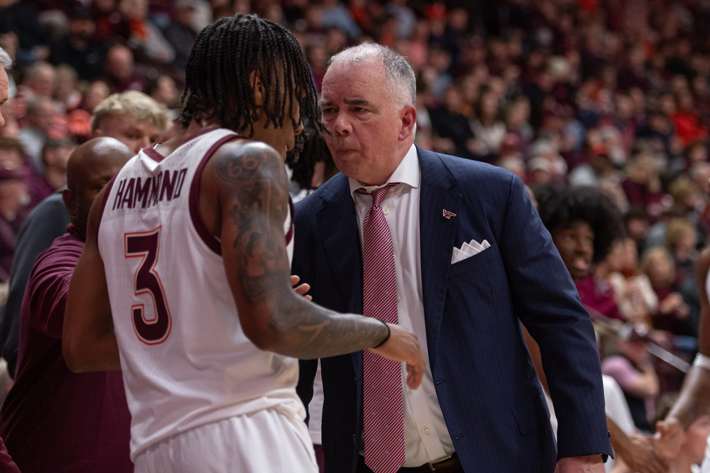 Virginia Tech head coach Mike Young talks to Virginia Tech guard Ben Hammond (3) during the first half of an NCAA college basketball game against Virginia, Wednesday, Dec. 31, 2025, in Blacksburg, Va. (AP Photo/Robert Simmons)