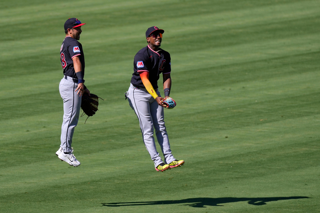 Cleveland Guardians' Steven Kwan, left, and Angel Martínez celebrate after the Guardians defeated the Los Angeles Angels in a baseball game Wednesday, Aug. 26, 2026, in Anaheim, Calif. (AP Photo/Mark J. Terrill)