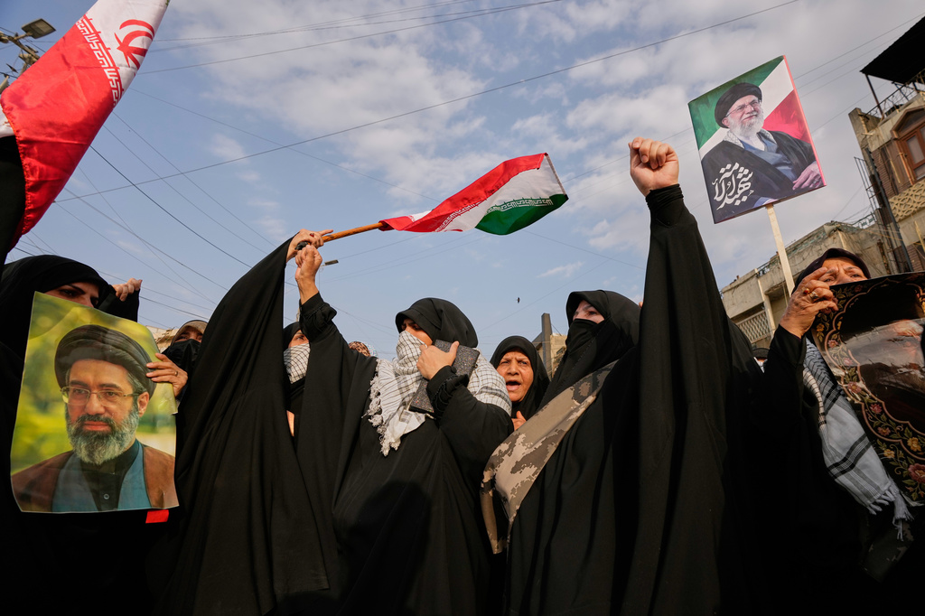 Iraqi Muslim women hold portraits of Iran's late Supreme Leader Ayatollah Ali Khamenei and his son Ayatollah Mojtaba Khamenei, during a protest against U.S. and Israeli attacks on multiple cities across Iran, in Baghdad, Iraq, Saturday, April 25, 2026. (AP Photo/Hadi Mizban)