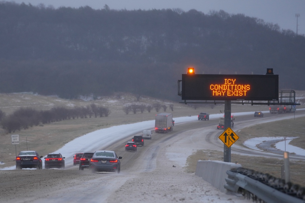 FILE - Vehicles travel eastbound on Interstate 20 near a sign advising motorists of icy conditions during a winter storm Jan. 24, 2026, in Dallas. (AP Photo/Julio Cortez, File)