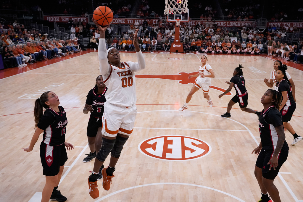 Texas center Kyla Oldacre (00) scores past Louisiana Lafayette guard Bianca Silva (13) during the first half of an NCAA college basketball game in Austin, Texas, Monday, Nov. 10, 2025. (AP Photo/Eric Gay)