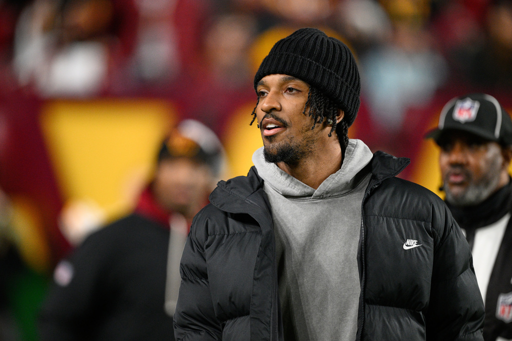 Washington Commanders quarterback Jayden Daniels is seen on the sidelines before an NFL football game against the Denver Broncos Sunday, Nov. 30, 2025, in Landover, Md. (AP Photo/Nick Wass)