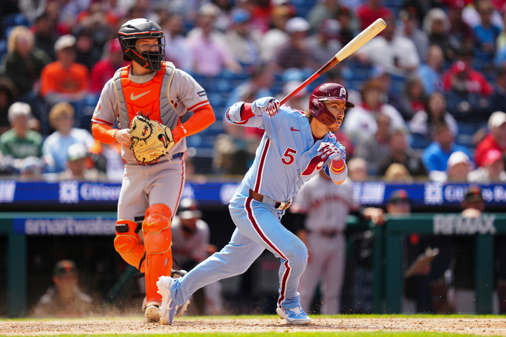 Philadelphia Phillies' Bryson Stott hits an RBI triple off San Francisco Giants pitcher Ryan Walker during the ninth inning of the first baseball game of a doubleheader, Thursday, April 30, 2026, in Philadelphia. (AP Photo/Derik Hamilton)