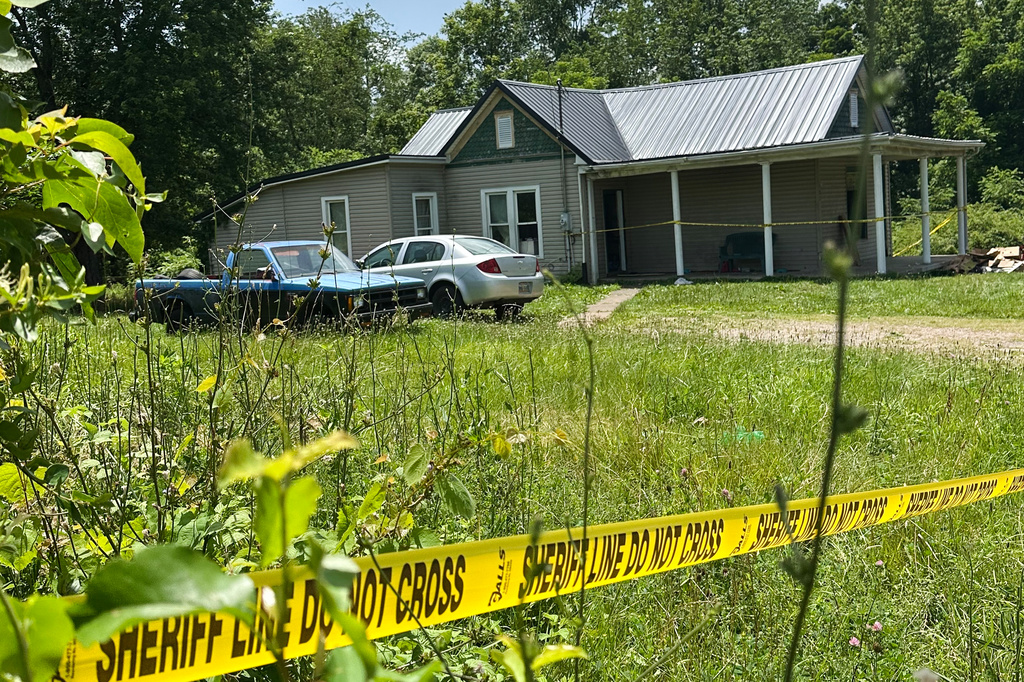 The dilapidated home where authorities say they removed 16 children and arrested four adults remains blocked off by crime scene tape on Wednesday, July 1, 2026 in Hamden, Ohio. (AP Photo/Julie Carr Smyth)