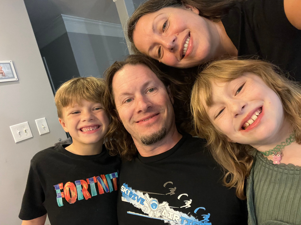 This Sept. 2024 photo provided by Kathryn Nold shows Nold and her husband, Dustin McKinney, and their two kids in Stilwell, Kansas. (Kathryn Nold via AP)