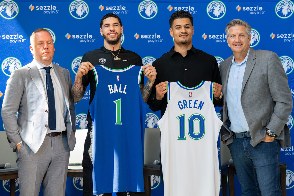 Tim Connelly, Minnesota Timberwolves president of basketball operations, newly acquired guards LaMelo Ball and Josh Green and head coach Chris Finch pose for a photo after an introductory press conference at the Target Center in Minneapolis on Tuesday, July 14, 2026. (Alex Kormann/Minnesota Star Tribune via AP)