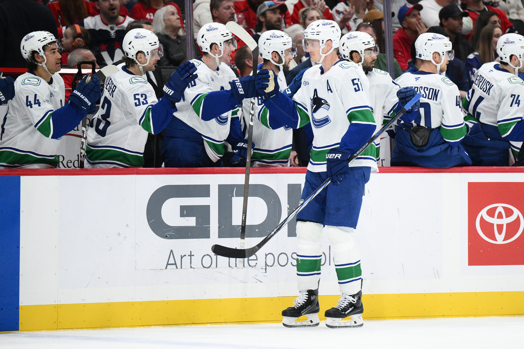 Vancouver Canucks defenseman Tyler Myers (57) celebrates his goal during the first period of an NHL hockey game against the Washington Capitals, Sunday, Oct. 19, 2025, in Washington. (AP Photo/Nick Wass)