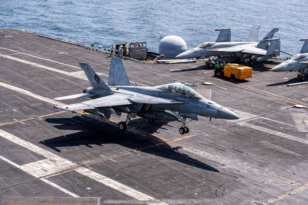 This image provided by U.S. Central Command shows a F/A-18E Super Hornet makes an arrested landing on the USS Abraham Lincoln (CVN 72) after a mission in support of Operation Epic Fury, on Saturday, Feb. 28, 2026. (U.S. Navy via AP)