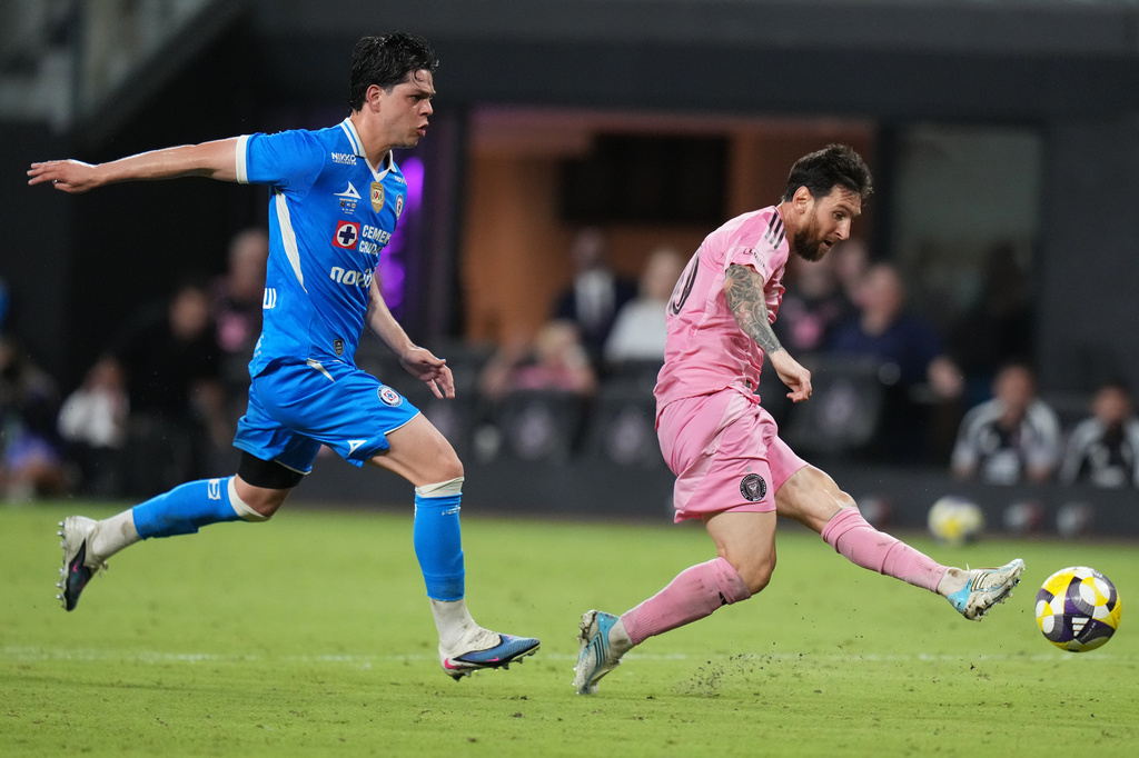 Cruz Azul midfielder Amaury García, left, defends as Inter Miami forward Lionel Messi, right, shoots on the goal, which was not allowed due an an offside penalty during the second half of the Campeones Cup soccer match, Wednesday, Sept. 16, 2026, in Miami. (AP Photo/Lynne Sladky)