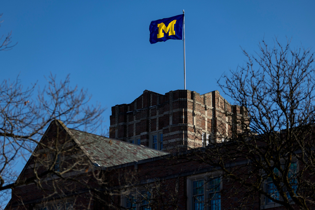 A flag blows in the wind atop the Michigan Union on the University of Michigan campus in Ann Arbor, Mich., Jan. 17, 2026. (AP Photo/Emily Elconin)