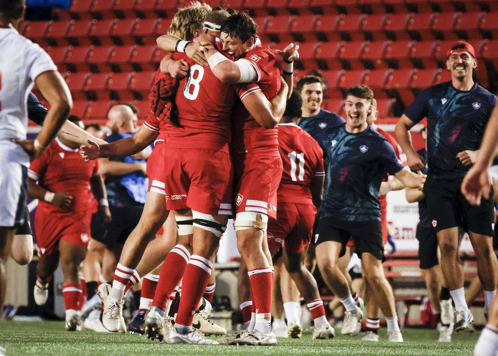 Canada's Tyler Ardron, center left, and Piers Von Dadelszen, center right, celebrate after defeating the United States in Pacific Nations Cup rugby match action in Calgary, Alberta, Friday, Aug. 22, 2025. (Jeff McIntosh/The Canadian Press via AP)