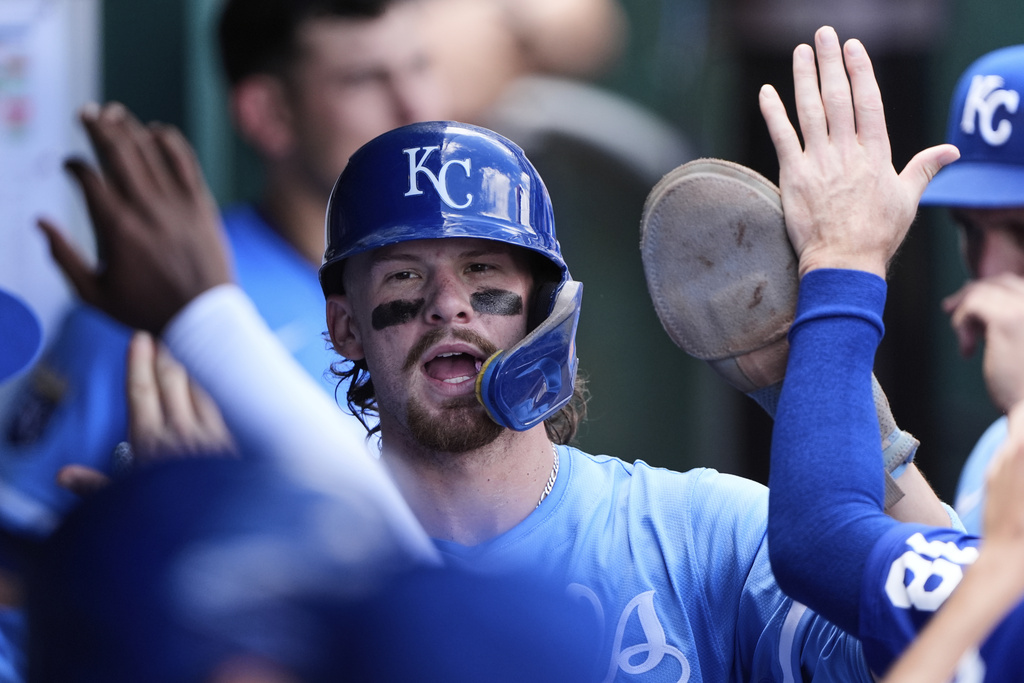 Kansas City Royals' Bobby Witt Jr. celebrates in the dugout after scoring on an RBI single hit by Salvador Perez during the third inning of a baseball game against the Texas Rangers, Thursday, Aug. 21, 2025, in Kansas City, Mo. (AP Photo/Charlie Riedel)