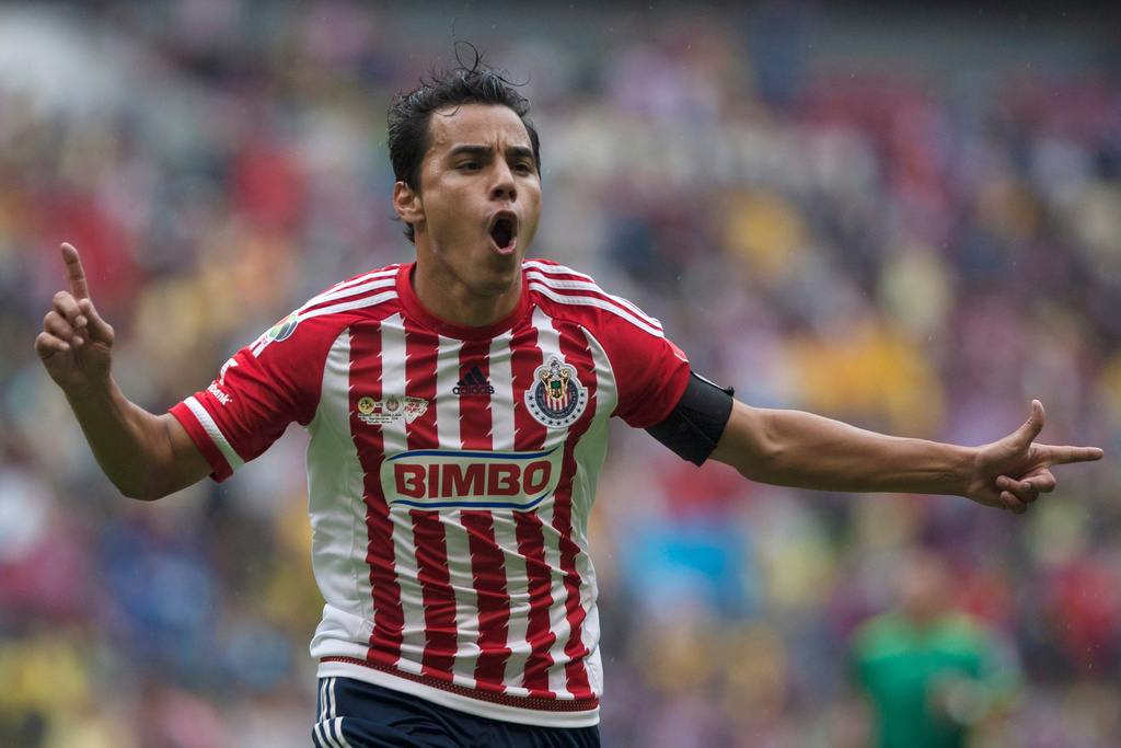 FILE - Chivas' Omar Bravo celebrates his goal against America during a Mexican soccer league match in Mexico City, Sept. 26, 2015. (AP Photo/Christian Palma, File)