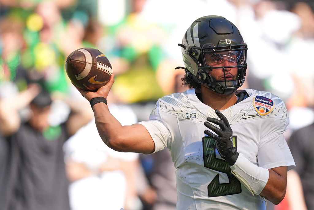 Oregon quarterback Dante Moore passes during the first half of the Orange Bowl College Football Playoff quarterfinal game, Thursday, Jan. 1, 2026, in Miami Gardens, Fla. (AP Photo/Rebecca Blackwell)