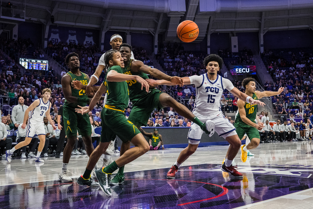 Baylor guard Cameron Carr (43), Baylor center James Nnaji (50), and TCU forward David Punch (15) look to rebound the ball during an NCAA college basketball game, Saturday, Jan. 3, 2026, Fort Worth, Texas. (AP Photo/Jessica Tobias)