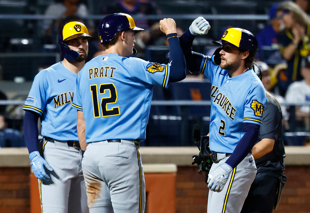 Milwaukee Brewers' Brice Turang (2) celebrates with Cooper Pratt (12) after hitting a three run home run against the New York Mets during the fourth inning of a baseball game, Wednesday, Aug. 26, 2026, in New York. (AP Photo/Noah K. Murray)