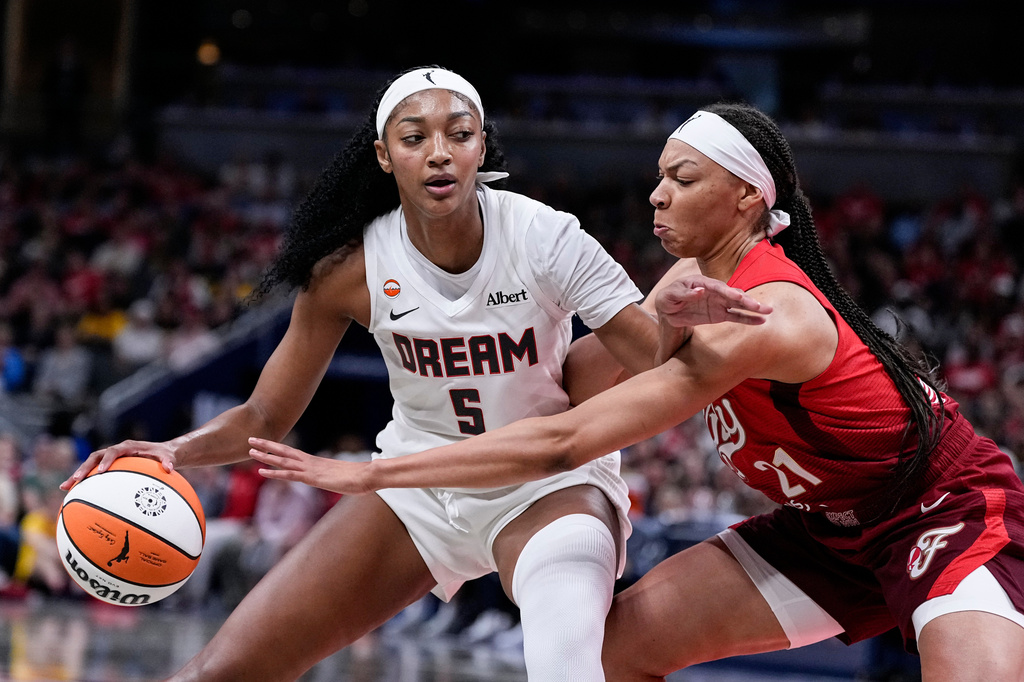 Indiana Fever forward Makayla Timpson (21) defends Atlanta Dream forward Angel Reese (5) in the second half of a WNBA basketball game in Indianapolis, Thursday, June 18, 2026. (AP Photo/Michael Conroy)