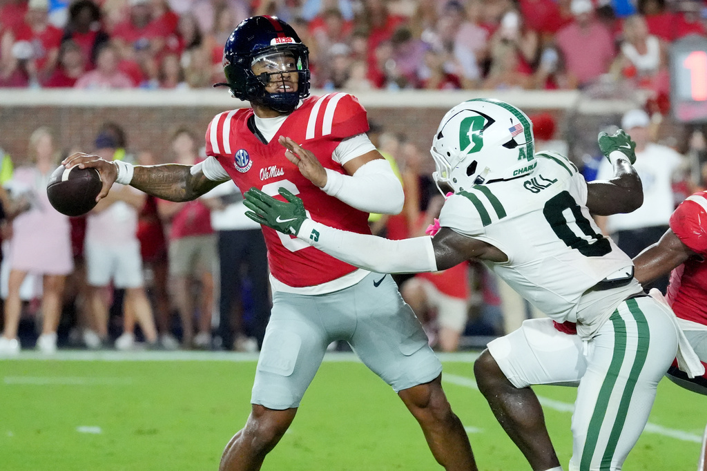 Mississippi quarterback Trinidad Chambliss (6) is pressured by Charlotte defensive back Collin Gill (0) as he attempts to pass during the first half of an NCAA college football game in Oxford, Miss., Saturday, Sept. 12, 2026. (AP Photo/Rogelio V. Solis)