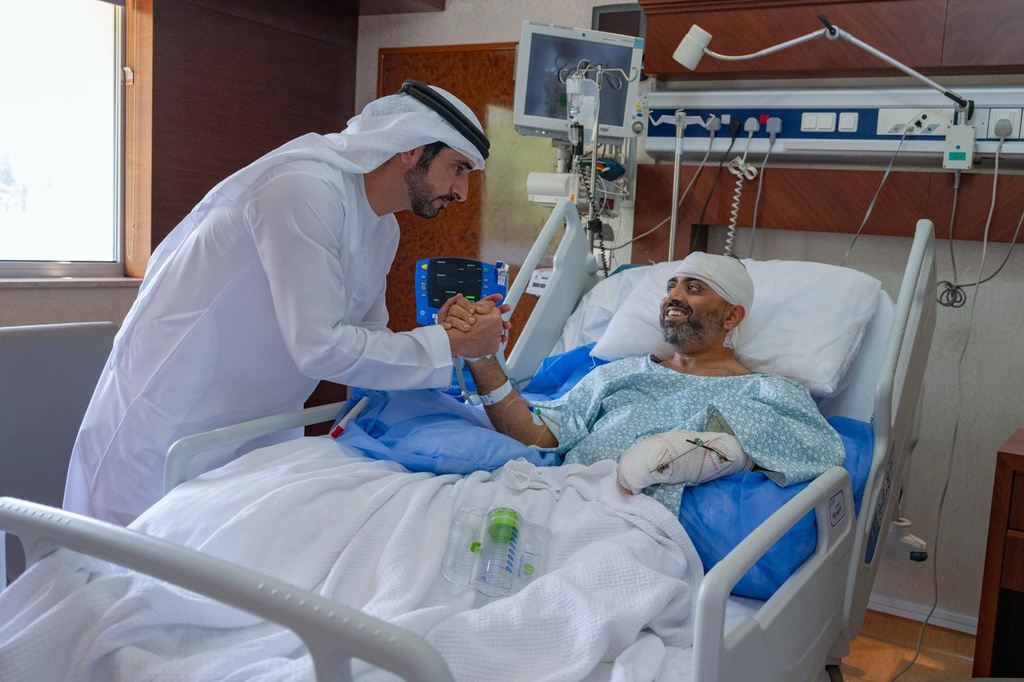In this photo provided by the Government of Dubai Media Office, Dubai Crown Prince Sheikh Hamdan bin Mohammed bin Rashid Al Maktoum, left, visits injured Indian Flydubai Capt. Smit Machchhar at a hospital in Abu Dhabi, United Arab Emirates, Friday, Oct. 2, 2026. (Government of Dubai Media Office via AP)