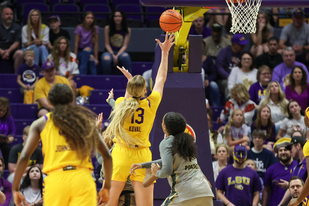 LSU forward Kate Koval (13) shoots a layup against Alabama State forward Kaia Ponder, center right, in the first half of an NCAA college basketball game in Baton Rouge, La., Sunday, Dec. 28, 2025. (AP Photo/Peter Forest)