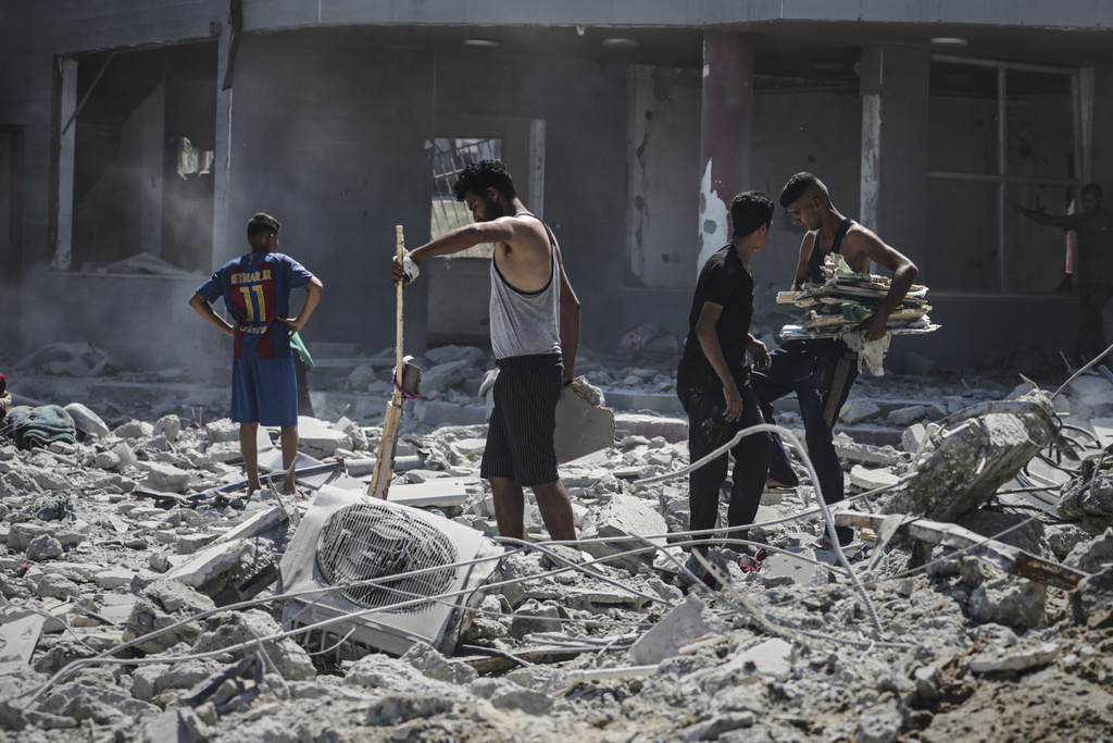 Palestinians inspect the damage after an Israeli army airstrike on a high-rise building in Gaza City, Friday, Sept. 5, 2025, after the Israeli army issued a prior warning. (AP Photo/Yousef Al Zanoun)