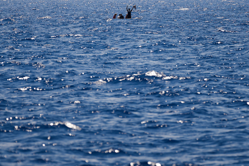 FILE-- Migrants from Syria and Libya in a wooden boat call for help as they are assisted by Spanish NGO Open Arms during a rescue operation inside Malta's SAR zone south of the Italian island of Lampedusa in the Mediterranean Sea, Wednesday, Aug. 10, 2022. (AP Photo/Francisco Seco)