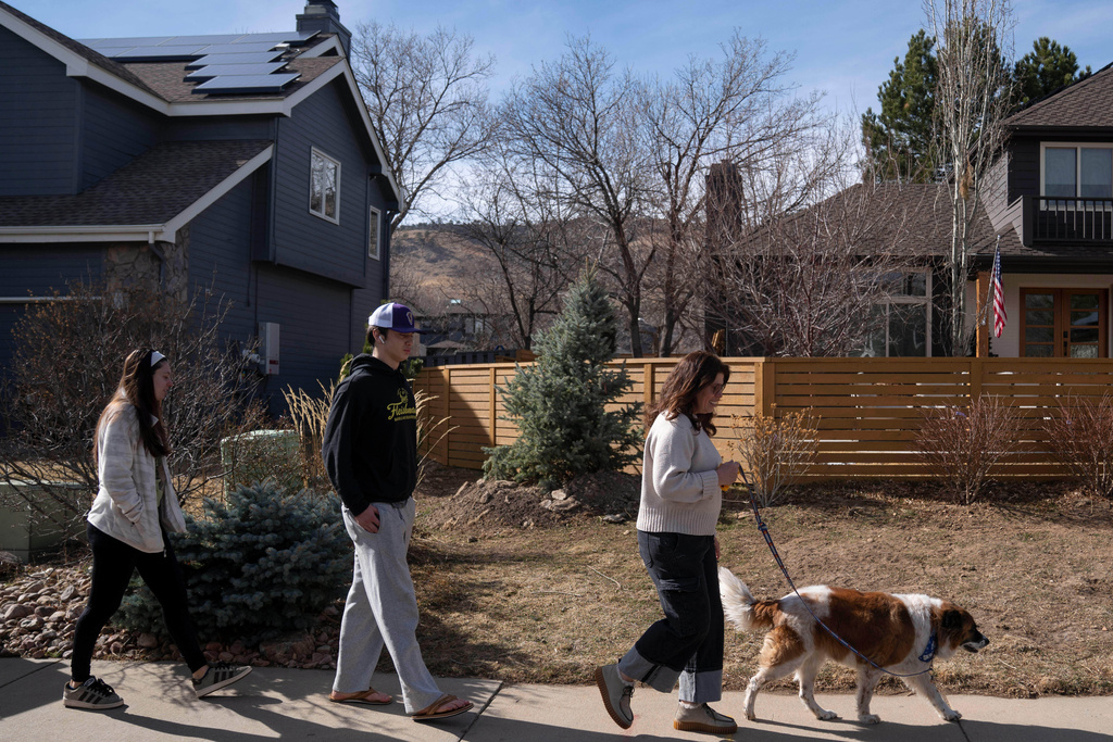 CEO of the Chef Ann Foundation, Mara Fleishman, a winner of this year's Elevate Prize; her son Jake Anderson, center; and daughter Lucy Anderson, left, take their family dog for a walk, Monday, Feb. 16, 2026, in Boulder, Colo. (AP Photo/Rebecca Slezak)