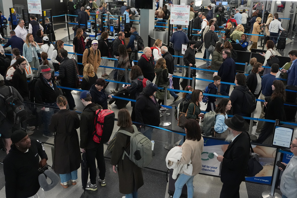 Travelers wait at a security checkpoint at O'Hare International Airport in Chicago, Friday, Nov. 7, 2025. (AP Photo/Nam Y. Huh)
