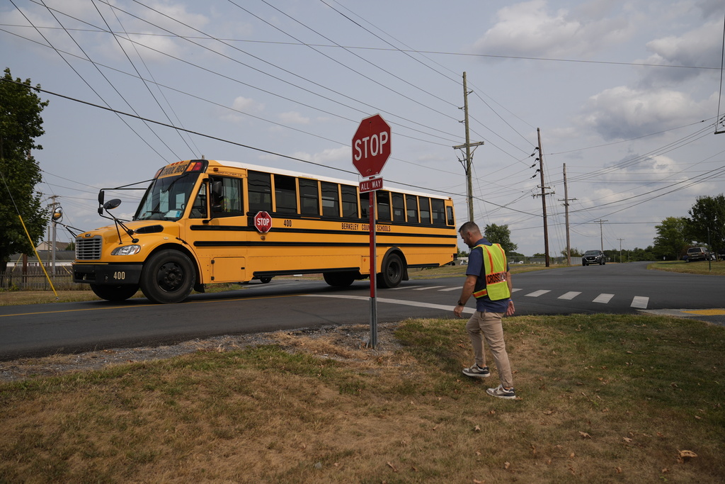 Crossing guard Travis Callis works outside Martinsburg North Middle School in Martinsburg, W.Va., on Sept. 5, 2025. (AP Photo/River Zhang)