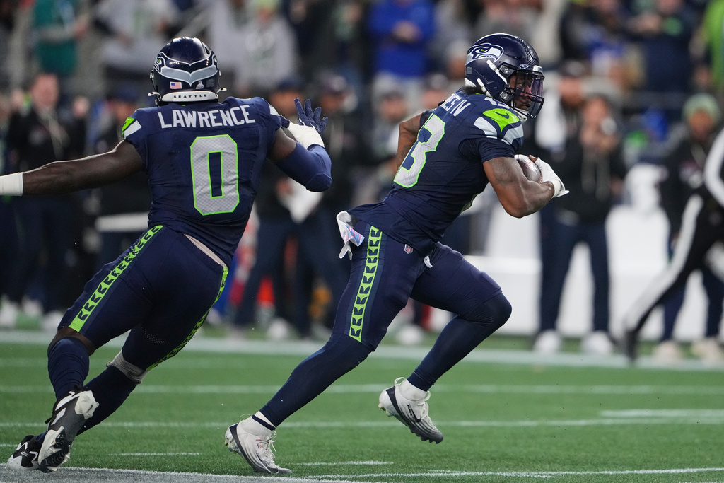 Seattle Seahawks' Ernest Jones IV (13) intercepts a pass as DeMarcus Lawrence (0) looks on in the second half of an NFL football game against the Houston Texans Monday, Oct. 20, 2025, in Seattle. (AP Photo/Lindsey Wasson)