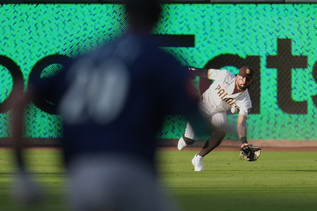 San Diego Padres right fielder Fernando Tatis Jr., right, makes the catch for the out on Seattle Mariners' Luke Raley, left, during the second inning of a baseball game Thursday, April 16, 2026, in San Diego. (AP Photo/Gregory Bull)