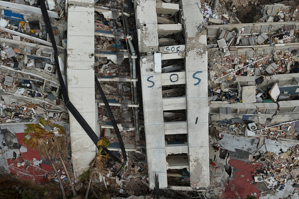 FILE - A building damaged during the earthquakes is marked with "S.O.S." painted stands in La Guaira, Venezuela, July 2, 2026. (AP Photo/Matias Delacroix, File)