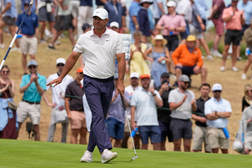 Brooks Koepka waves after his putt on the 10th hole during the second round of the U.S. Open golf tournament at Shinnecock Hills Golf Club in Southampton, N.Y., Friday, June 19, 2026.(AP Photo/Seth Wenig)