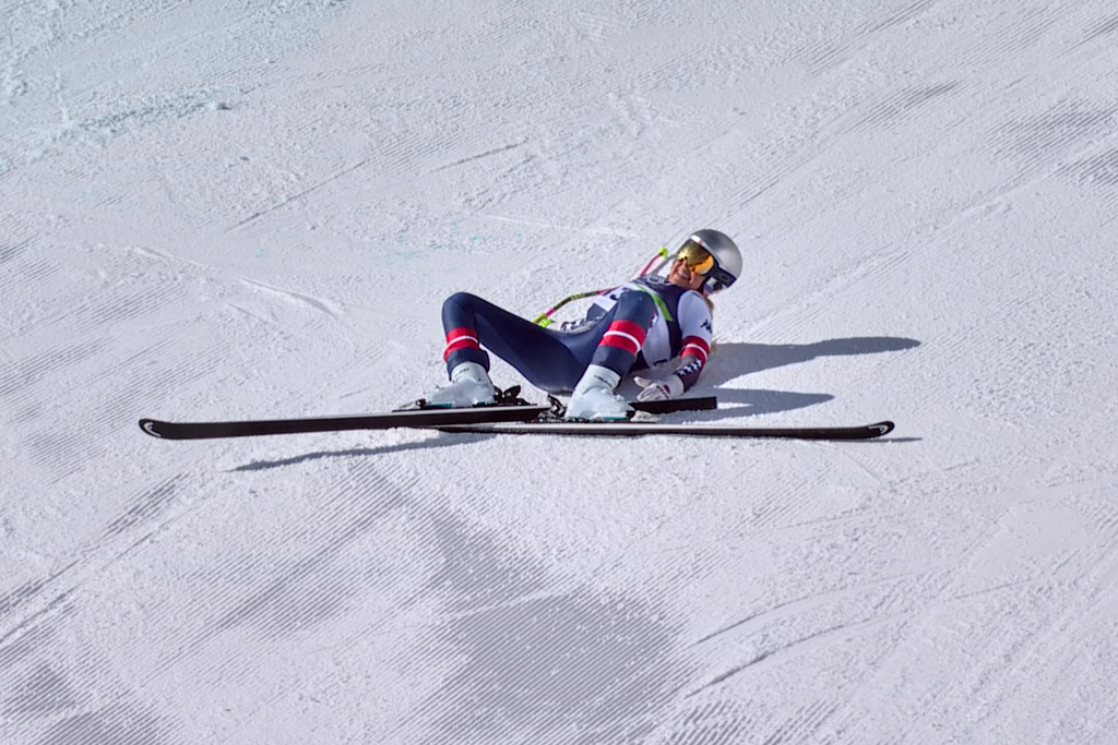 In this image taken from video provided by Olympic Broadcasting Services, OBS, United States' Lindsey Vonn lays on the course after crashing during an alpine ski women's downhill race, at the 2026 Winter Olympics, in Cortina d'Ampezzo, Italy, Sunday, Feb. 8, 2026. (Olympic Broadcasting Services via AP)