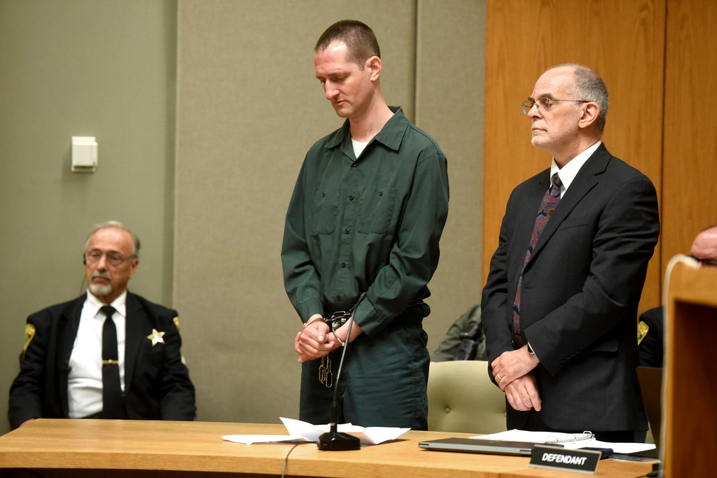 Flanked by his lawyer Richard Guerriero, right, Robert Tulloch, center, listens as Judge Lawrence MacLeod reads out his new sentence in the case of murdering two Dartmouth College professors as a teenager during a hearing on Monday, July 13, 2026, in Grafton Superior Court in North Haverhill, N.H. (Jennifer Hauck/Valley News via AP, Pool)
