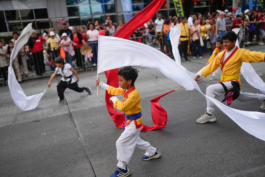 People perform during a parade celebrating the Lunar New Year in Panama City, Sunday, Feb. 22, 2026. (AP Photo/Matias Delacroix)