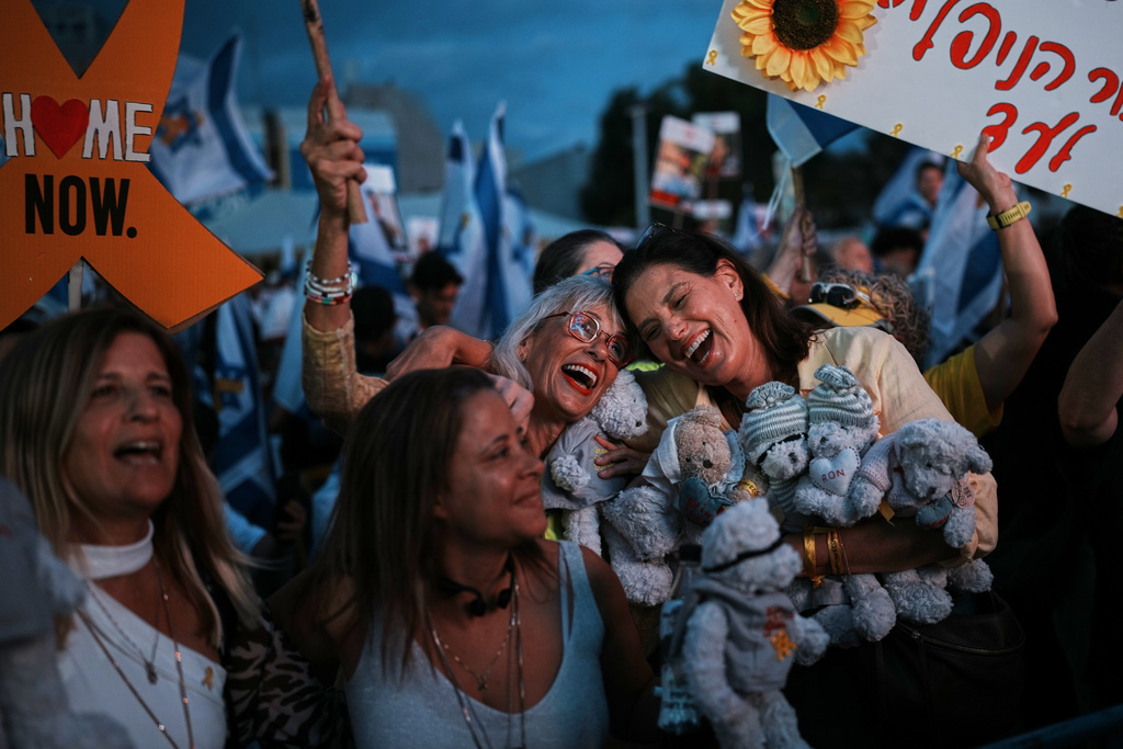 People gather prior to the release of Israeli hostages held in Gaza, at a plaza known as the hostages square in Tel Aviv, Israel, Monday, Oct. 13, 2025. (AP Photo/Emilio Morenatti)
