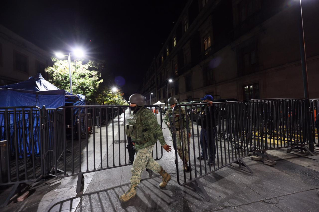Army soldiers patrol outside the National Palace ahead of the daily, morning news conference by Mexican President Claudia Sheinbaum in Mexico City, Monday, Feb. 23, 2026. (AP Photo/Ginnette Riquelme)