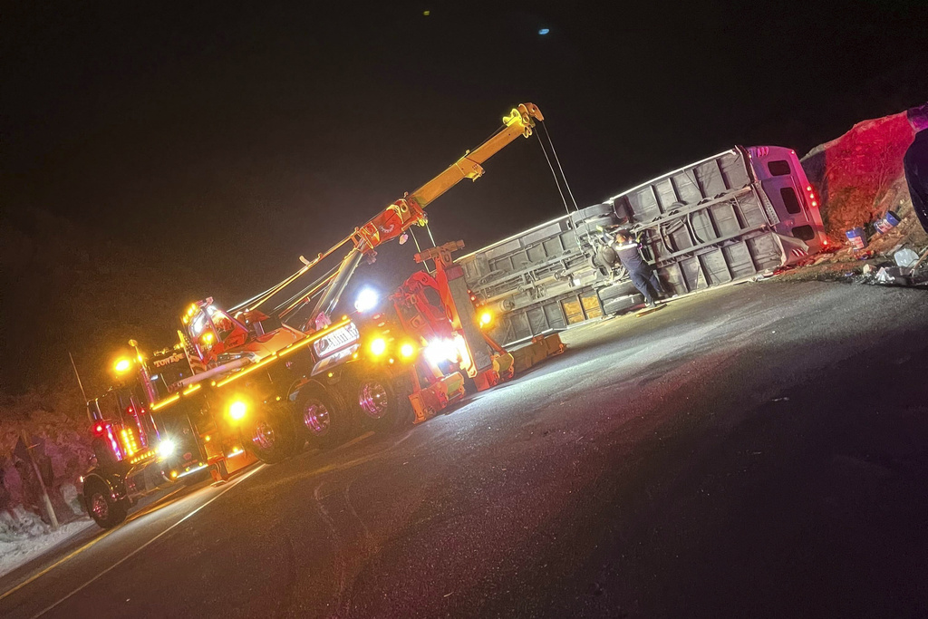 This photo provided by Mario Sanchez shows a bus that was carrying teens and young adults returning from a church camp overturned after it lost control and tipped onto its side on a two-lane highway Sunday, Nov. 9, 2025, near Running Springs, Calif. (Mario Sanchez via AP)