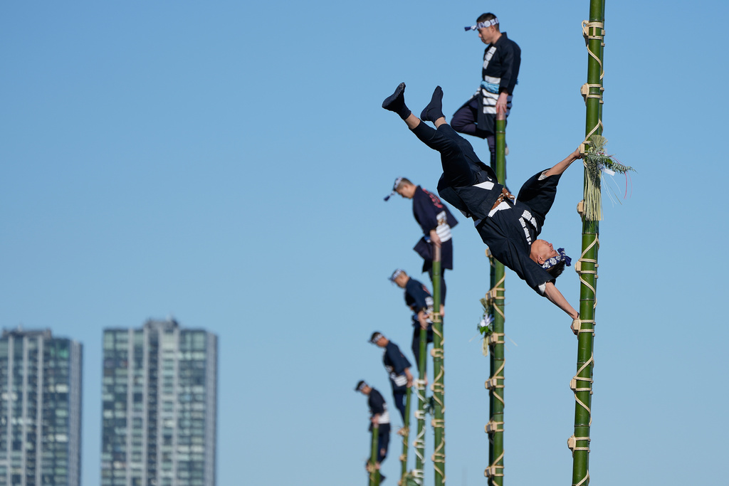 Members of a traditional firefighting preservation group perform ladder stunts during the annual New Year's Fire Brigade Review Tuesday, Jan. 6, 2026, in Tokyo. (AP Photo/Eugene Hoshiko)