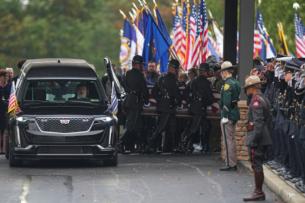 Pall bearers carry the coffin of a slain officer during funeral services for Northern York County Regional Police detectives Cody Michael Becker, Mark Edward Baker and Isaiah Emenheiser, Thursday, Sept. 25, 2025, in Red Lion, Pa. (AP Photo/Matt Rourke)