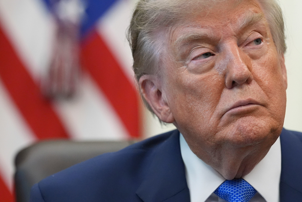President Donald Trump listens during a meeting to sign an executive order about vaccines, Monday, Aug. 10, 2026, in the Oval Office of the White House in Washington. (AP Photo/Jacquelyn Martin)