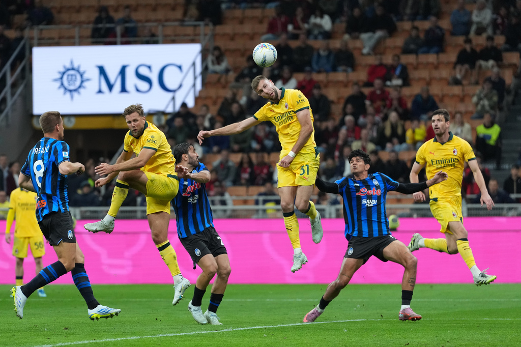 AC Milan's Strahinja Pavlovic, center, scores his side's opening goal during the Serie A soccer match between AC Milan and Atalanta, in Milan, Italy, Sunday, May 10, 2026. (AP Photo/Antonio Calanni)