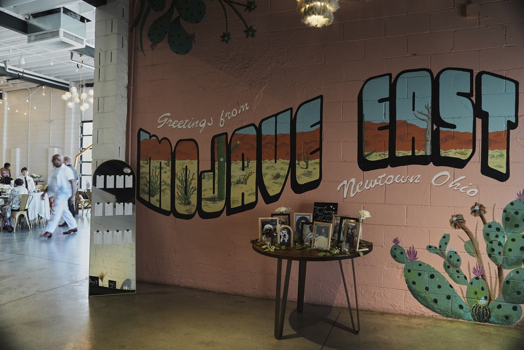 Family photos sit on display in the entrance to Mojave East before a wedding Saturday, Aug. 23, 2025, in Newtown, Ohio. (AP Photo/Joshua A. Bickel)