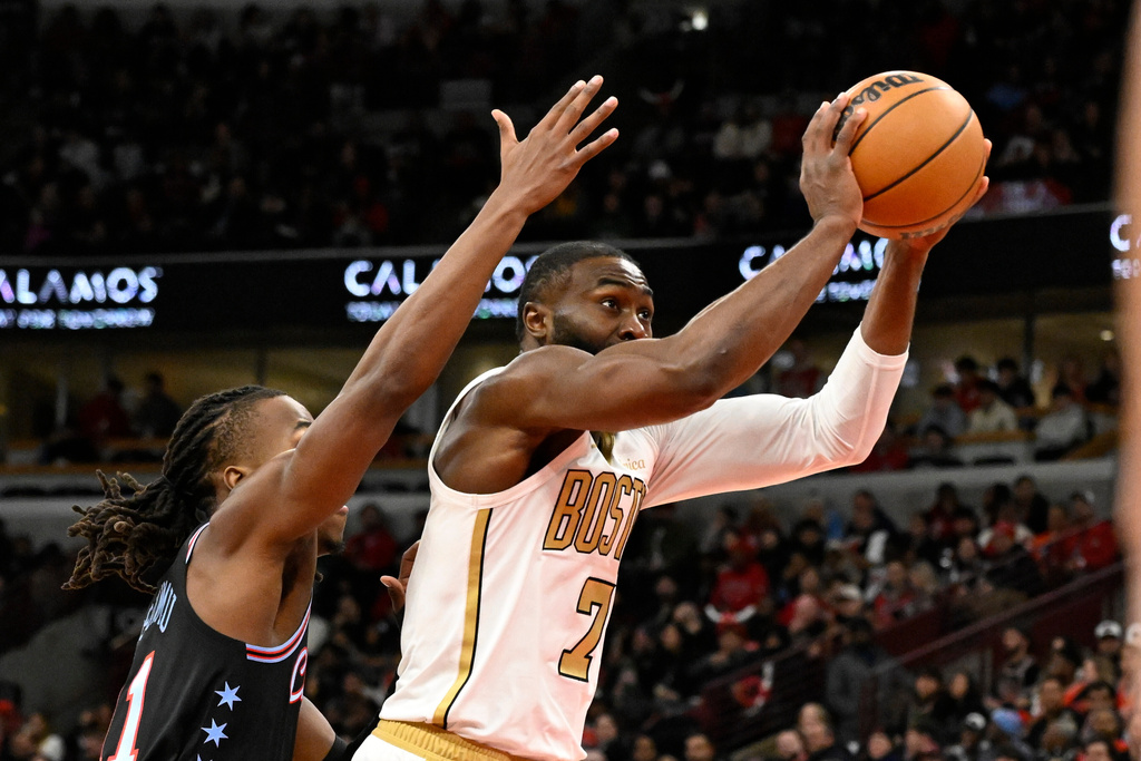 Boston Celtics guard Jaylen Brown (7) shoots against Chicago Bulls guard Ayo Dosunmu during the first half of an NBA basketball game Monday, Jan. 24, 2026, in Chicago. (AP Photo/Matt Marton)